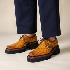 Amber ostrich Derby with elevated sole worn with deep indigo wide-leg trousers