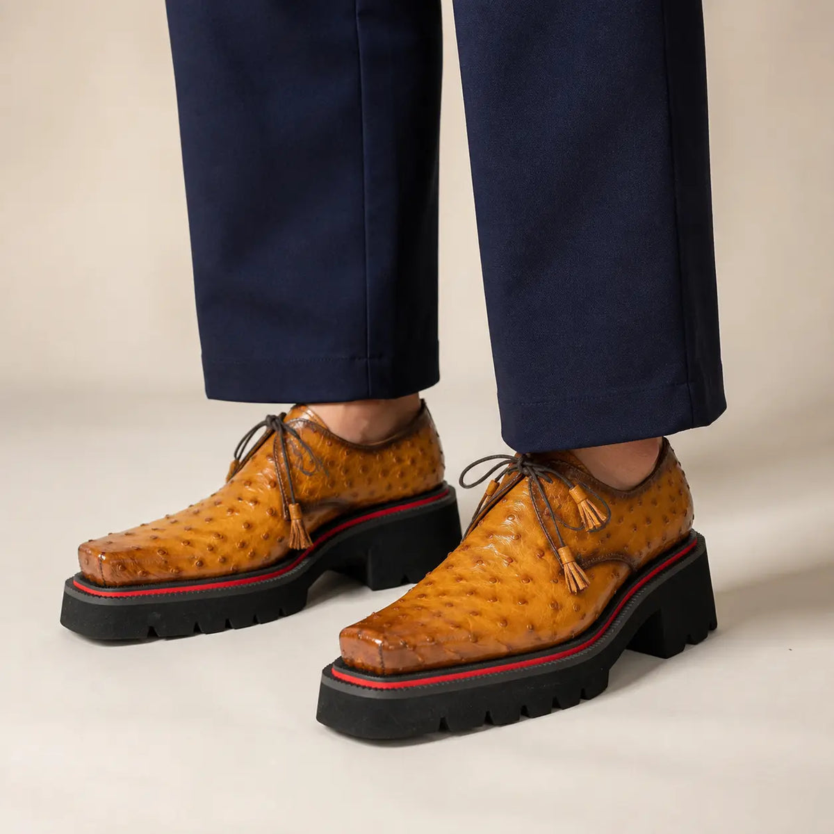 Amber ostrich Derby with elevated sole worn with deep indigo wide-leg trousers