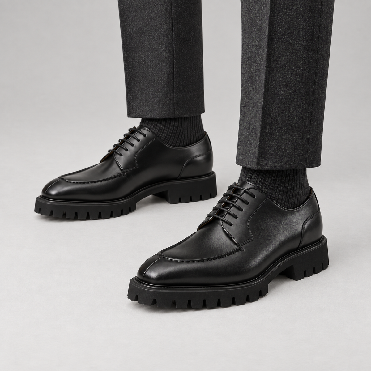 Black calfskin apron-toe Derby lug sole shoes — premium on-foot studio view