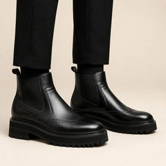 Black Brogued Chelsea Boots with Lug Sole — on-foot studio view