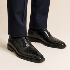 DIVINCH black crocodile Norwegian Oxford shoes on foot with navy trousers