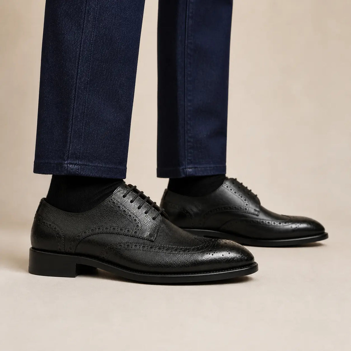 Black grain wingtip Derby shoes on foot