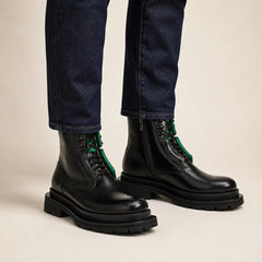 Black side-zip lug sole boots with denim on-foot studio photo