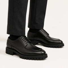 Black Lug Sole Apron Derby — on-foot studio view