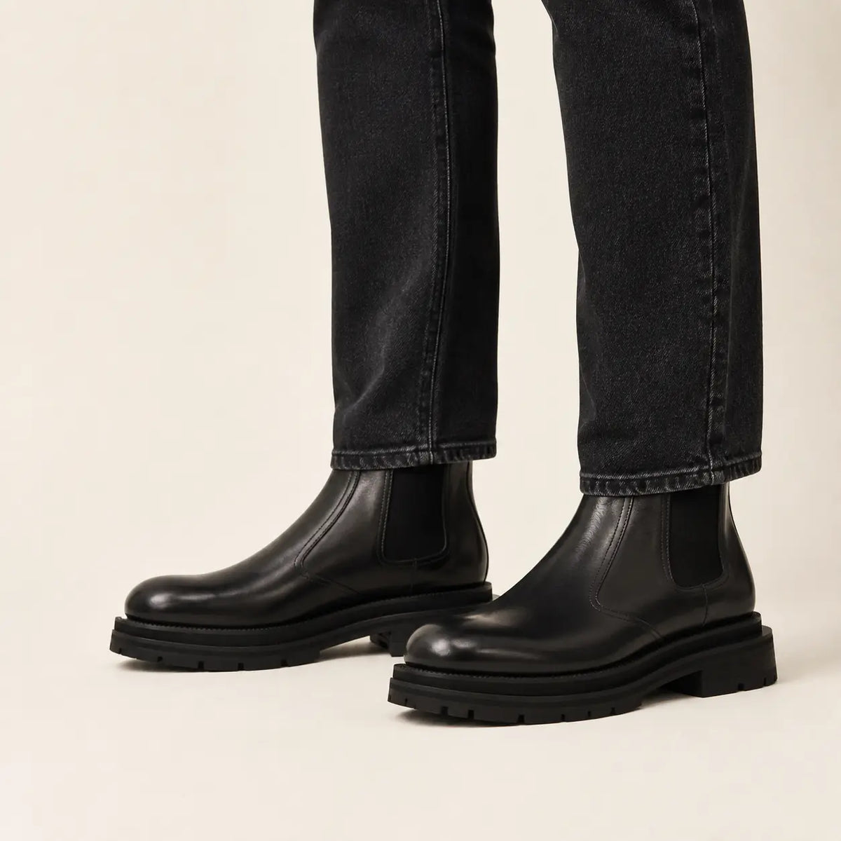 Black lug sole Chelsea boots on-foot studio photo