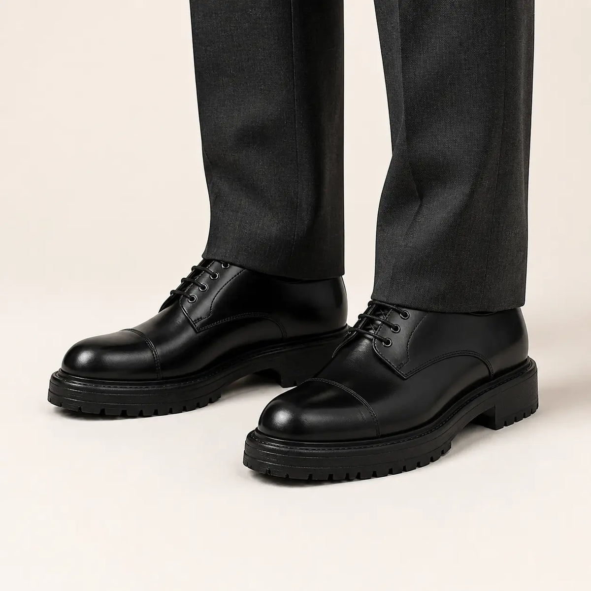 Black Lug Sole Derby on foot, warm off-white studio