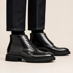 Black lug sole moc-toe boots on foot
