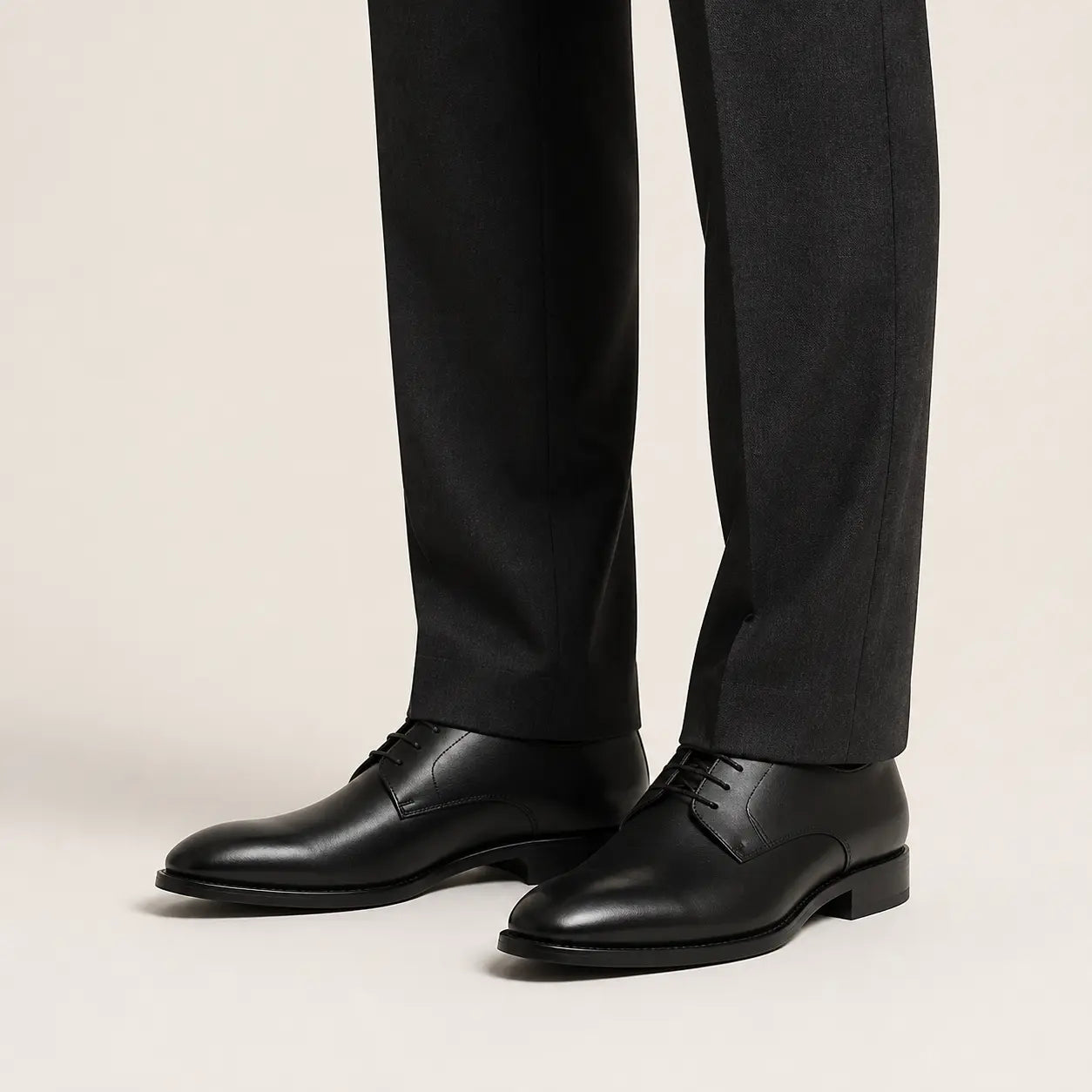 Black Minimalist Derby on foot, warm off-white studio
