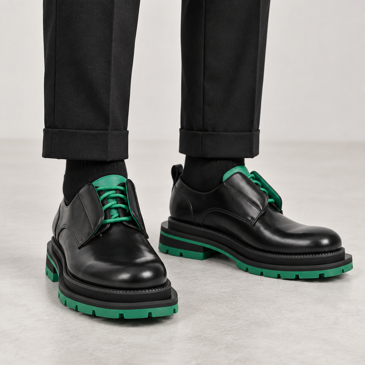 Black and green lug-sole derby shoes on foot, no shoe trees
