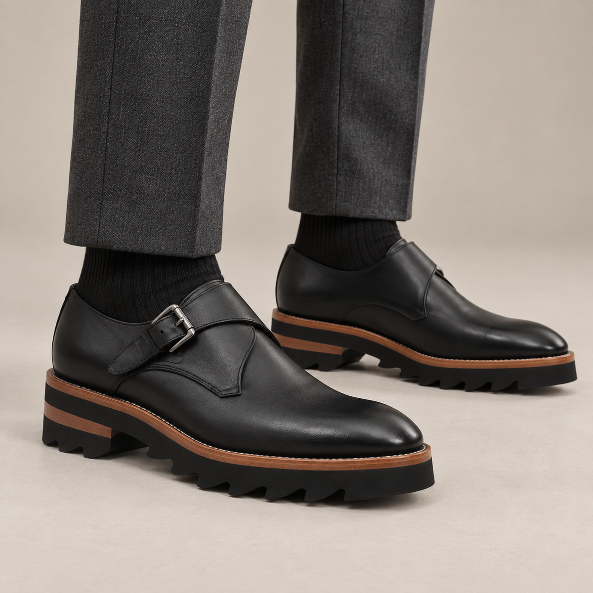 Black glossy plain-toe monk-strap shoes — on-foot studio view
