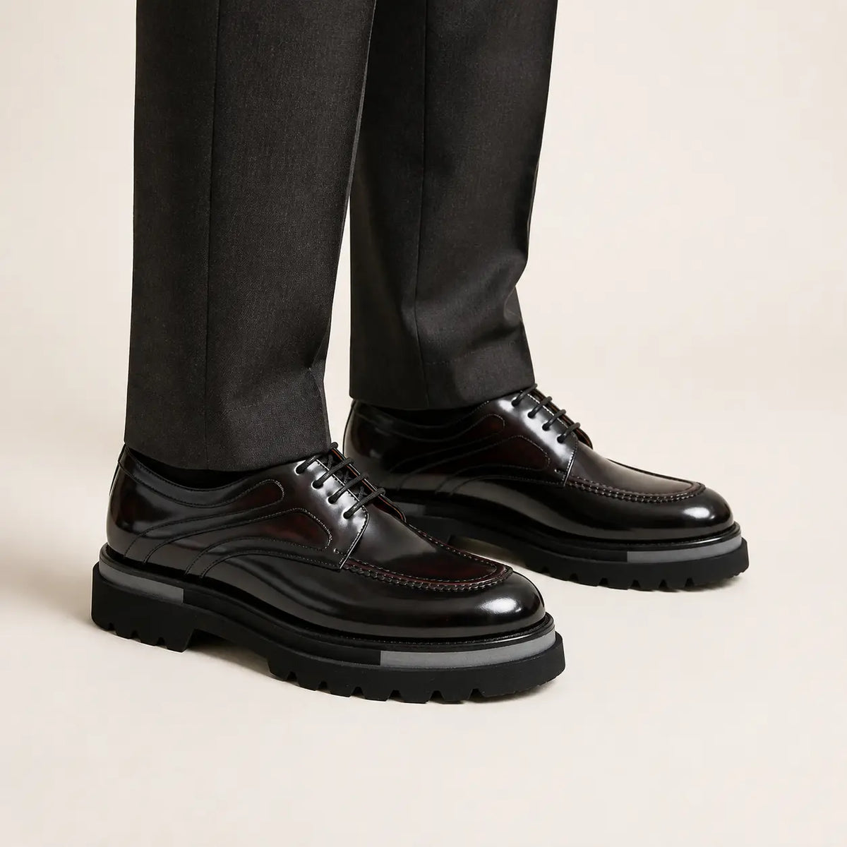 On-foot studio view of dark oxblood polished moc-toe lug derby