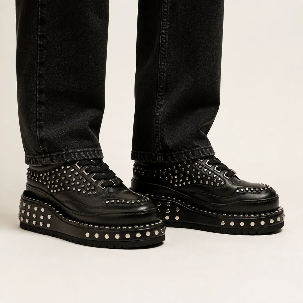 Black Heavy Studded Platform Sneaker — on-foot studio view
