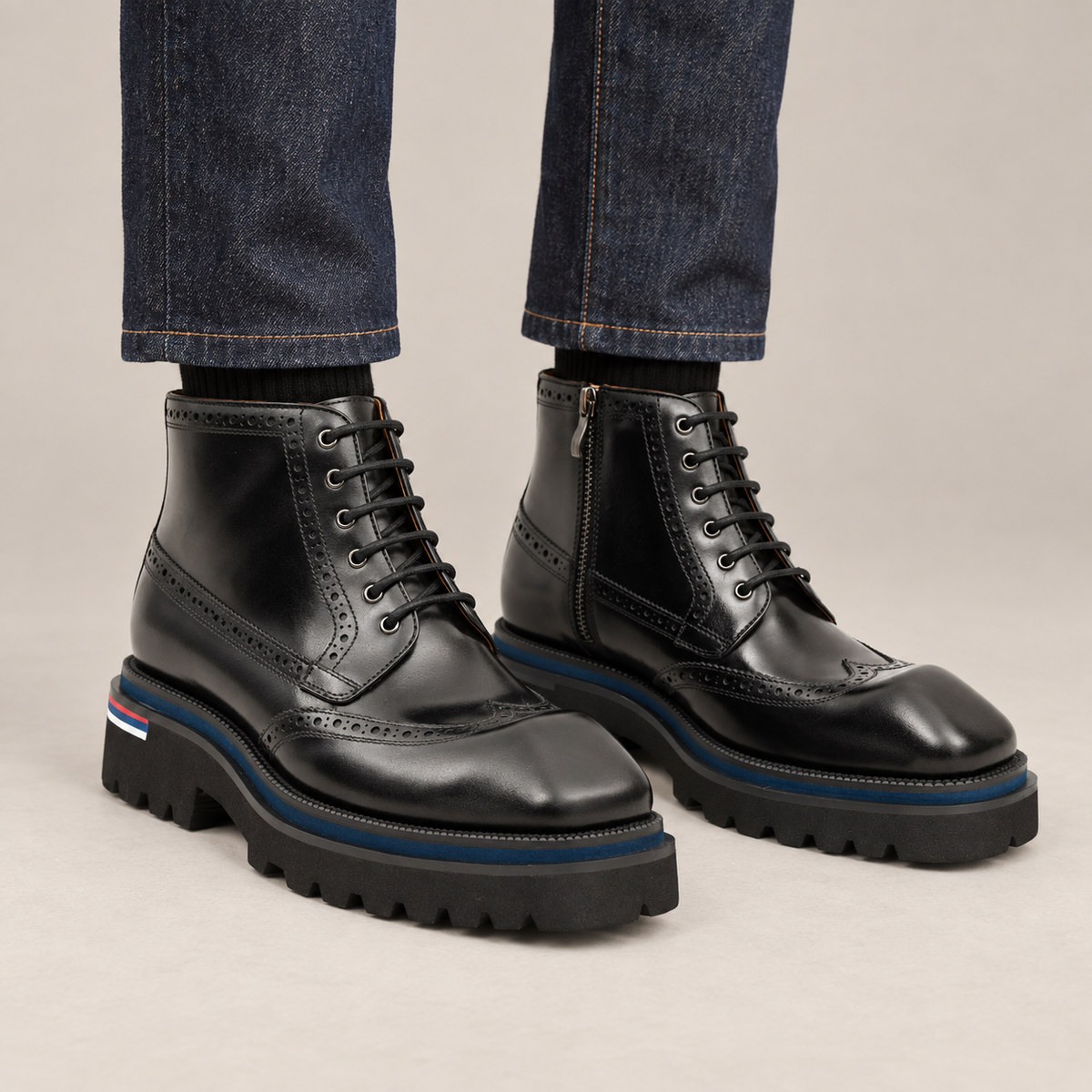 Black Wingtip Lace-Up Ankle Boots with Metal Eyelets — on-foot studio view