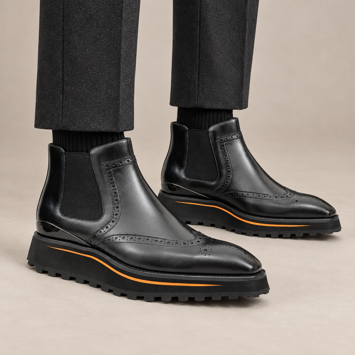 Black wingtip Chelsea boots with brown-edge lug sole on model lower legs, DIVINCH 2891B
