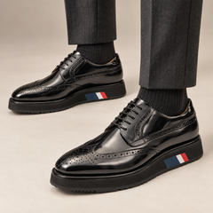 Black platform wingtip Derby shoes — premium on-foot studio view