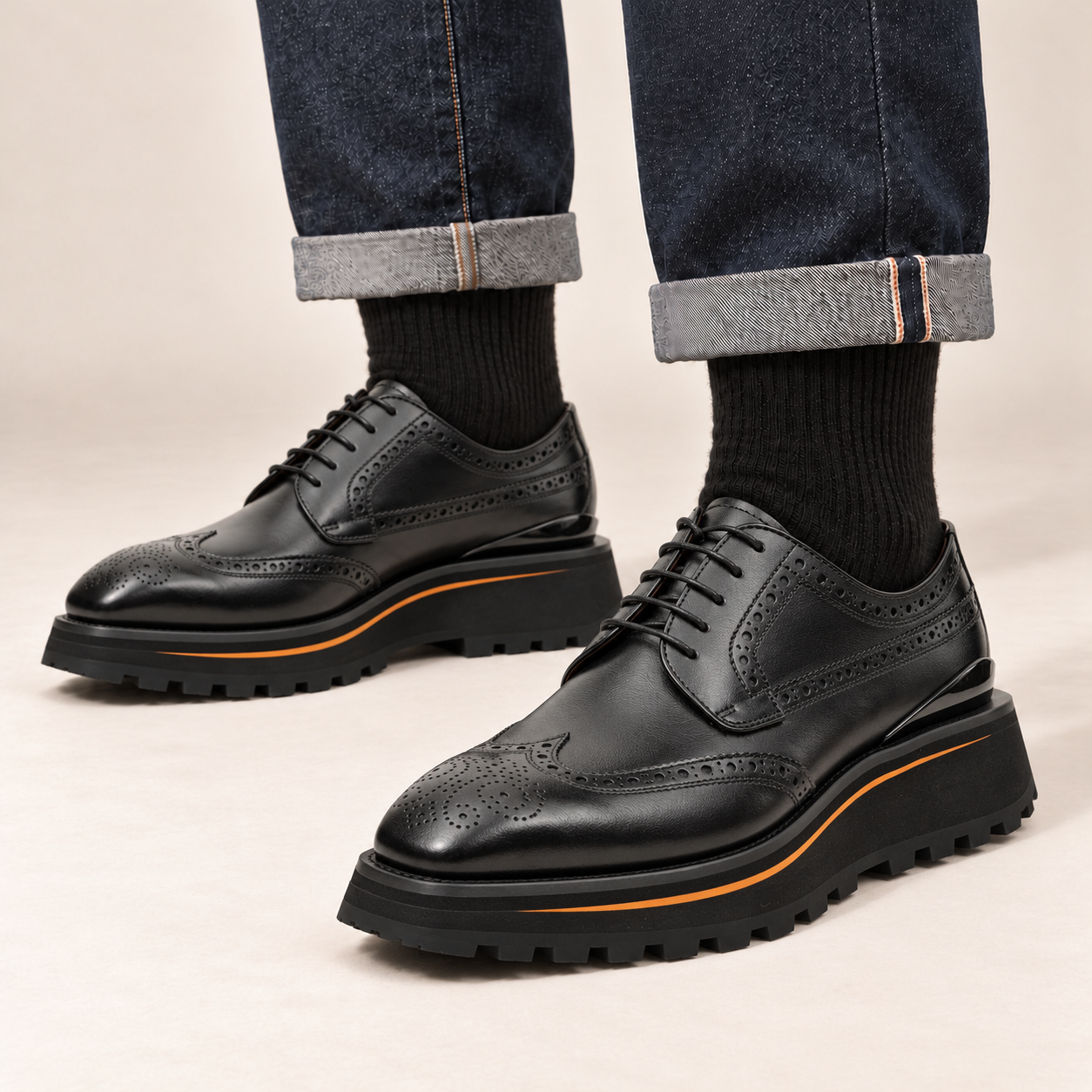 Black wingtip Derby shoes 2886B worn with cuffed indigo jeans in a cream studio