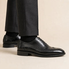 DIVINCH Black Wingtip Oxford Brogues on foot — warm studio side profile, no shoe tree