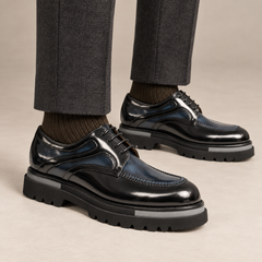 DIVINCH black and dark blue layered-panel moc-toe Derby shoes worn with tailored charcoal trousers