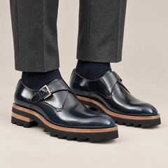 Dark blue single monk shoes with brown-band ridged sole — premium on-foot studio view