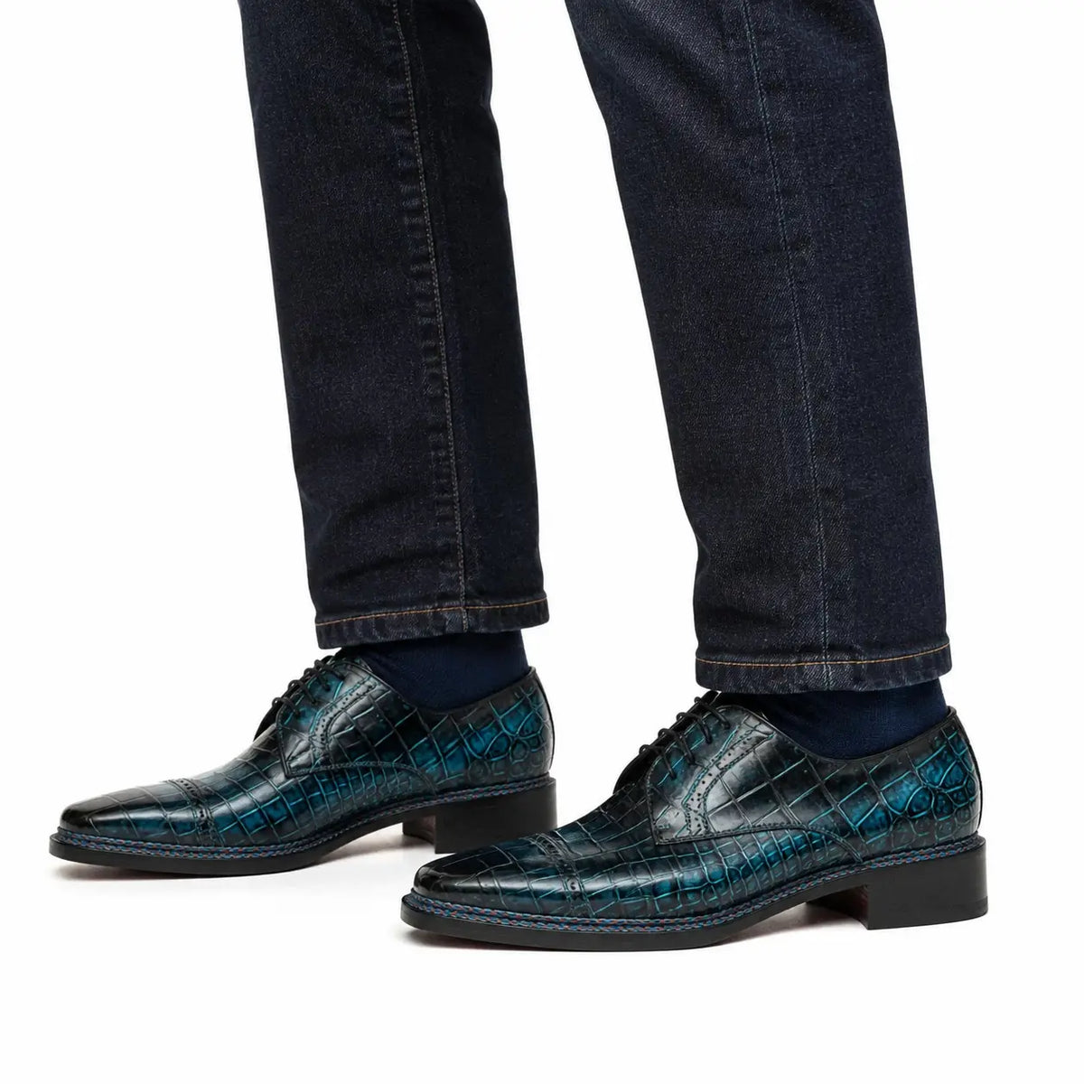 Blue crocodile cap-toe Derby shoes on foot