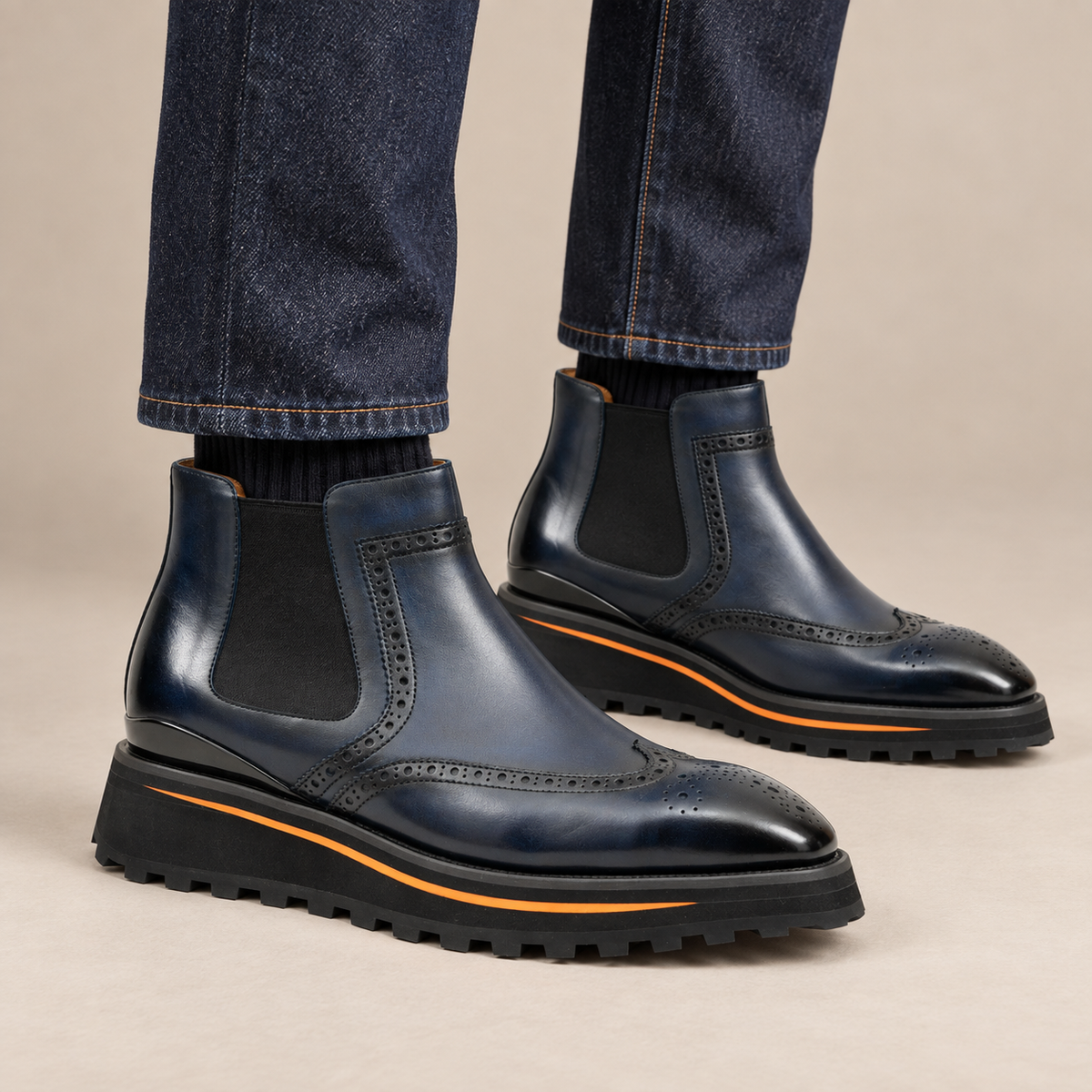 Dark blue wingtip Chelsea boots with brown-edge lug sole on model lower legs, DIVINCH 2891D