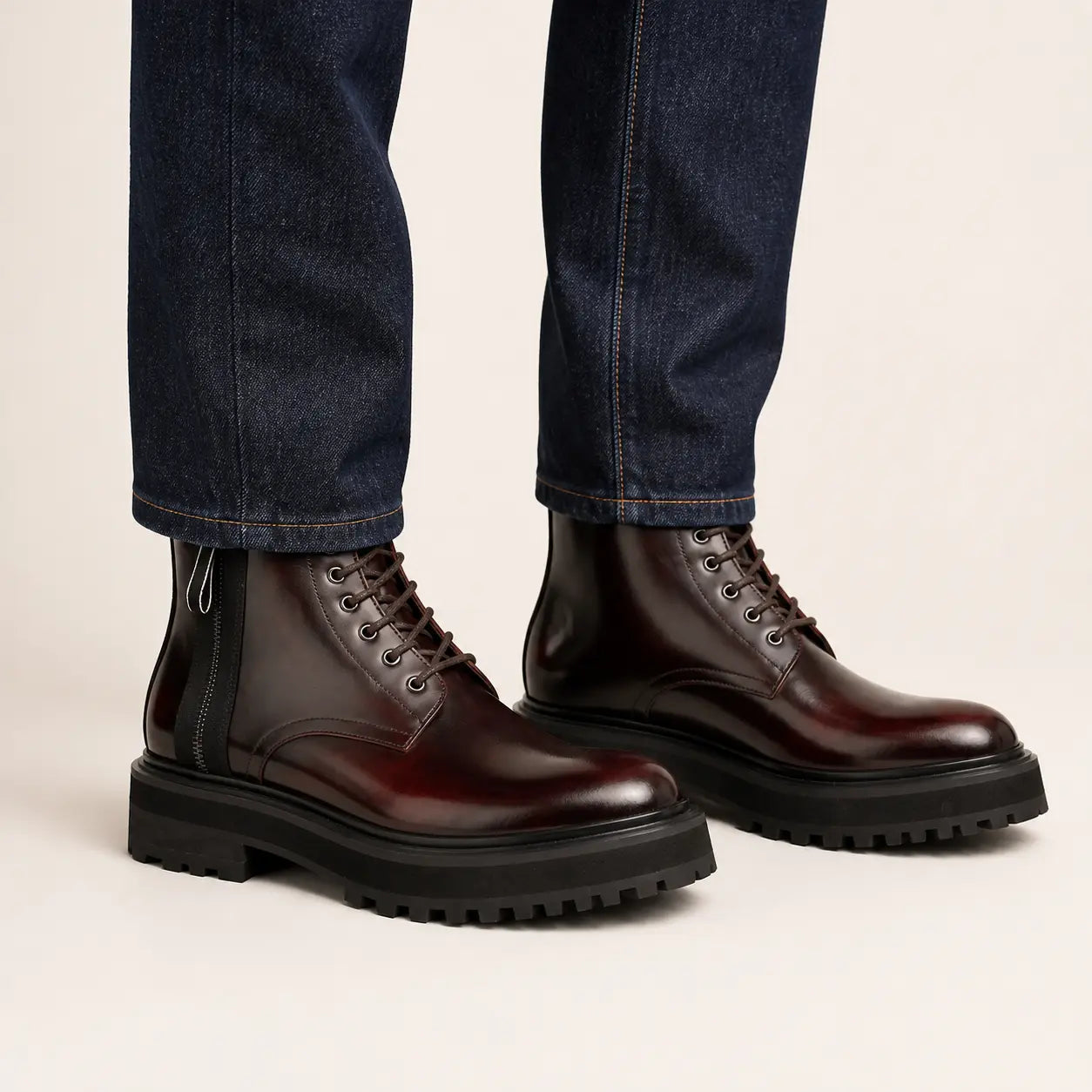 Bordeaux Zip Combat Boot — on-foot studio view with indigo denim
