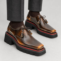 Brown square-toe Derby shoes on foot