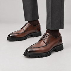 Brown calfskin apron-toe Derby lug sole shoes — premium on-foot studio view