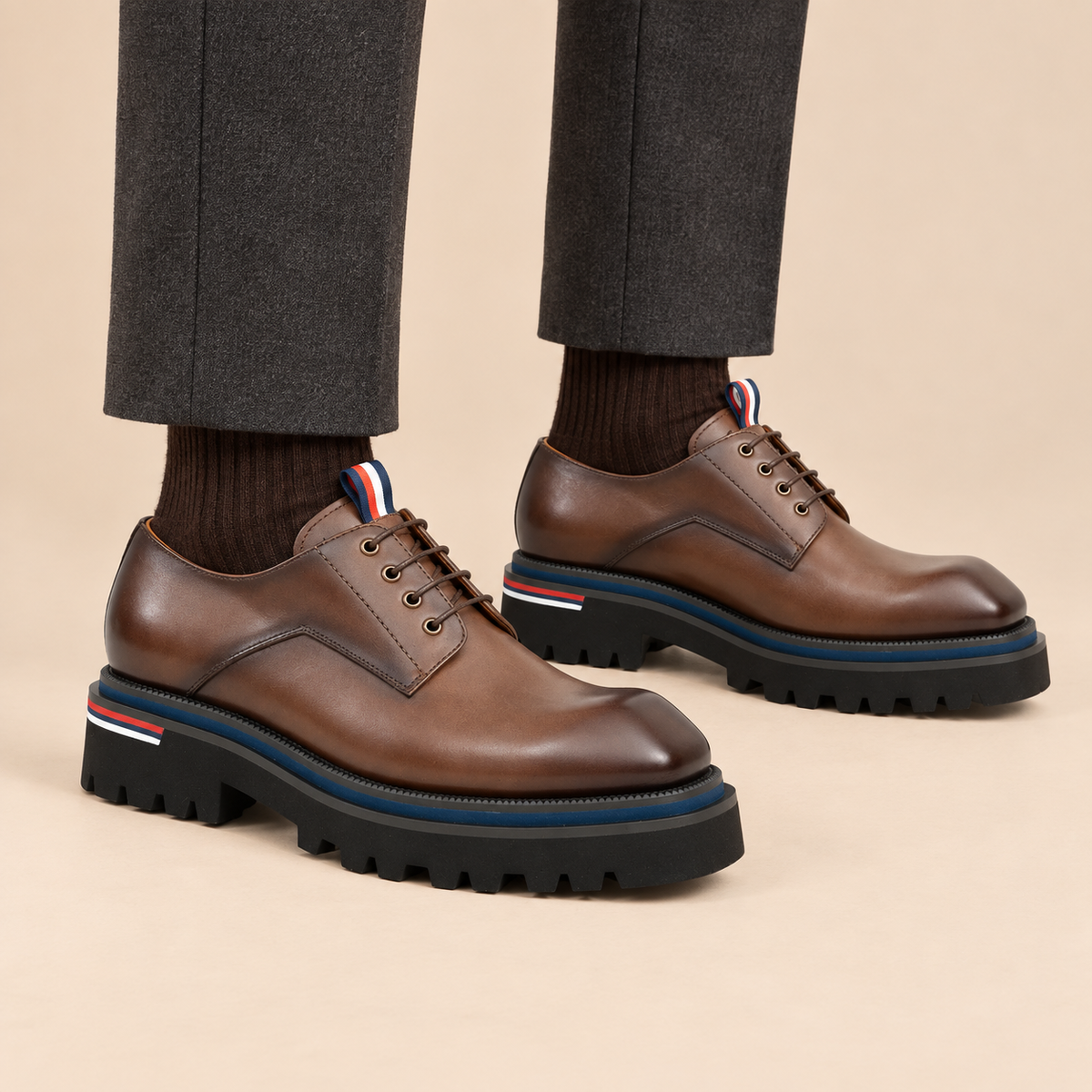 Taupe-brown plain-toe Derby shoes with pull tab on model