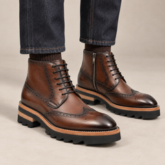 Brown wingtip ankle boots with side zipper and ridged sole on model lower legs, DIVINCH 7003A
