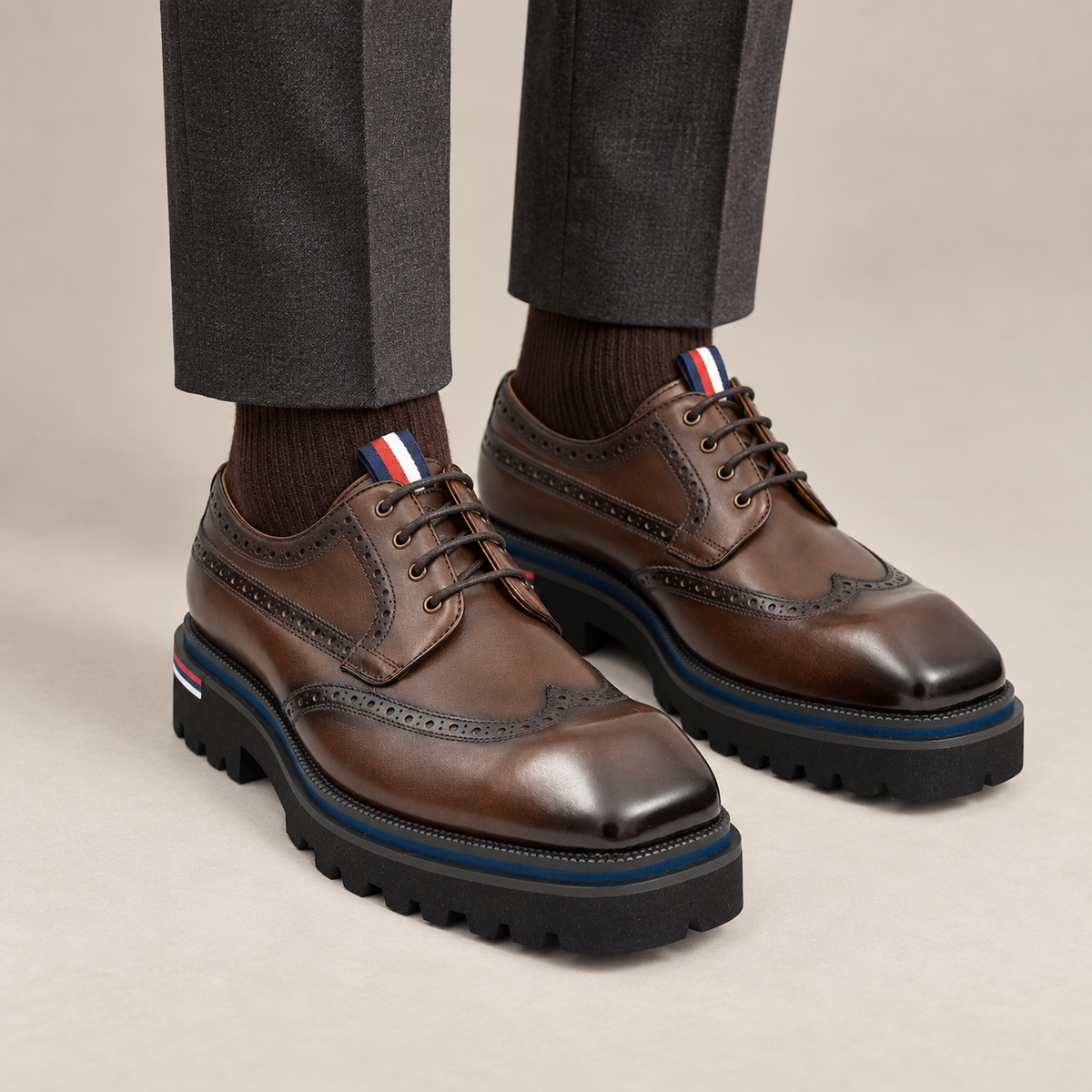 Brown Wingtip Derby Shoes with Metal Eyelets — on-foot studio view
