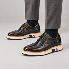 Dark blue-black and brown wingtip Derby shoes with contrast platform sole — premium on-foot studio view