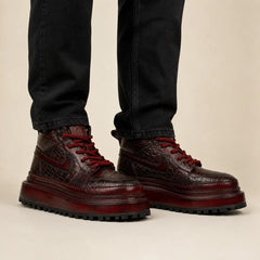Burgundy crocodile platform boots on-foot studio photo
