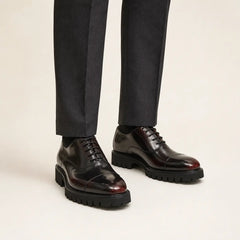 Burnished cap-toe lug-sole Oxford shoes on foot