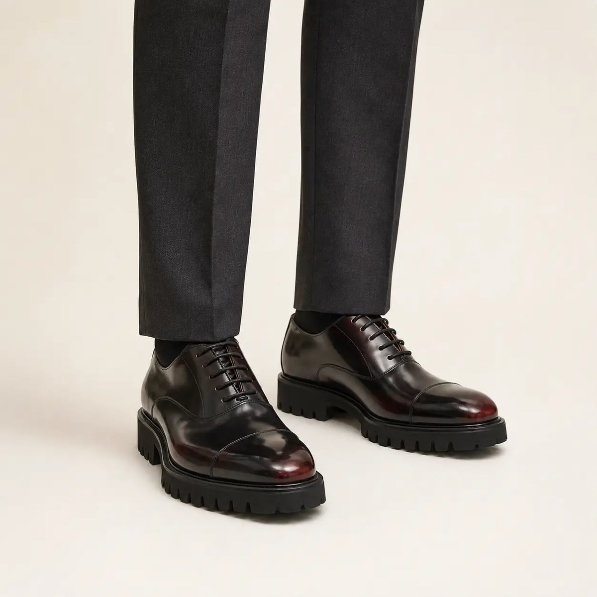 Burnished cap-toe lug-sole Oxford shoes on foot