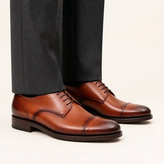 DIVINCH cognac cap-toe derby — on-foot studio view