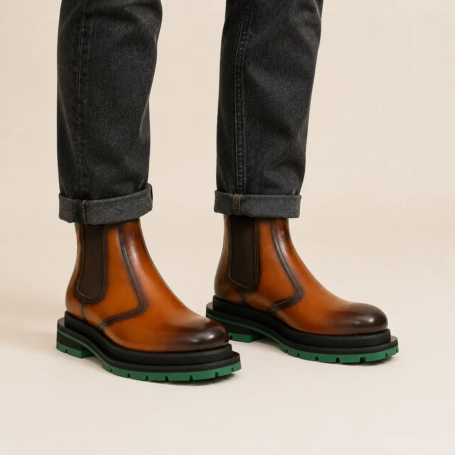 Cognac Chelsea boots with green lug sole on-foot studio photo