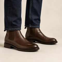 Dark brown Chelsea boots on foot