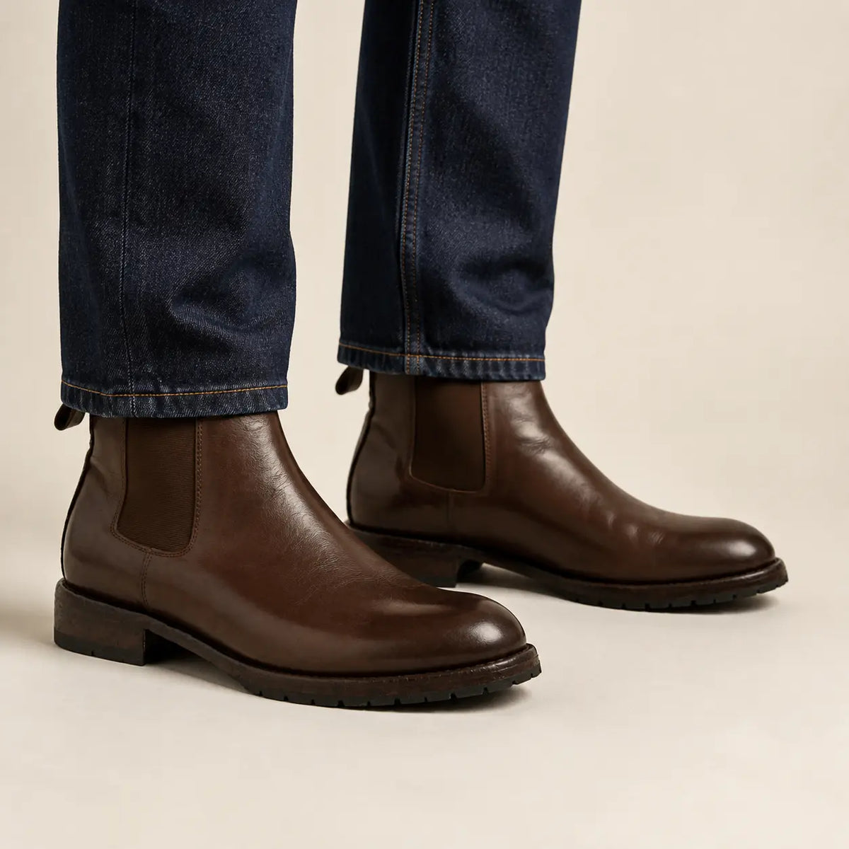 Dark brown Chelsea boots on foot
