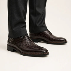 Dark brown crocodile Derby shoes on foot