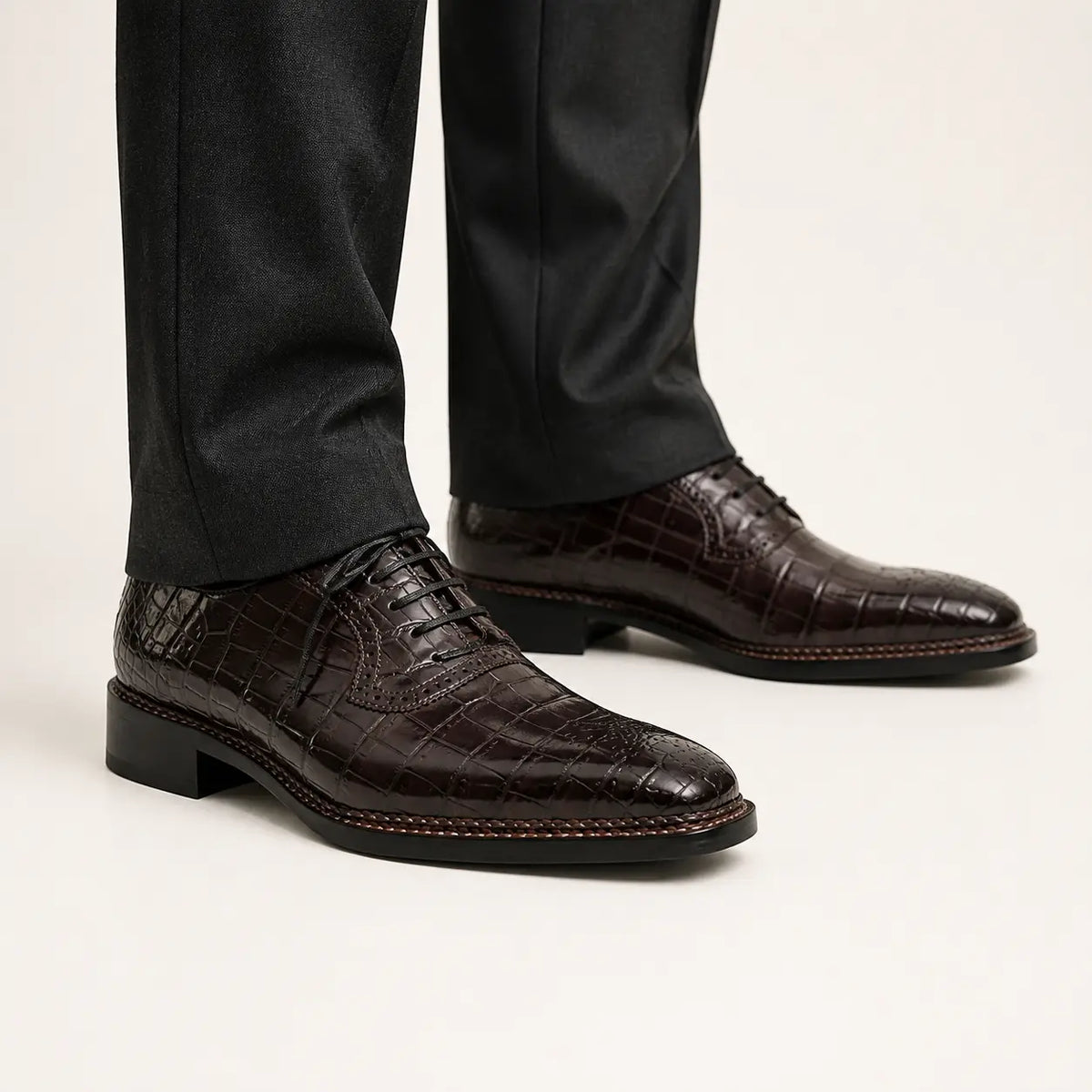 Dark brown crocodile Derby shoes on foot