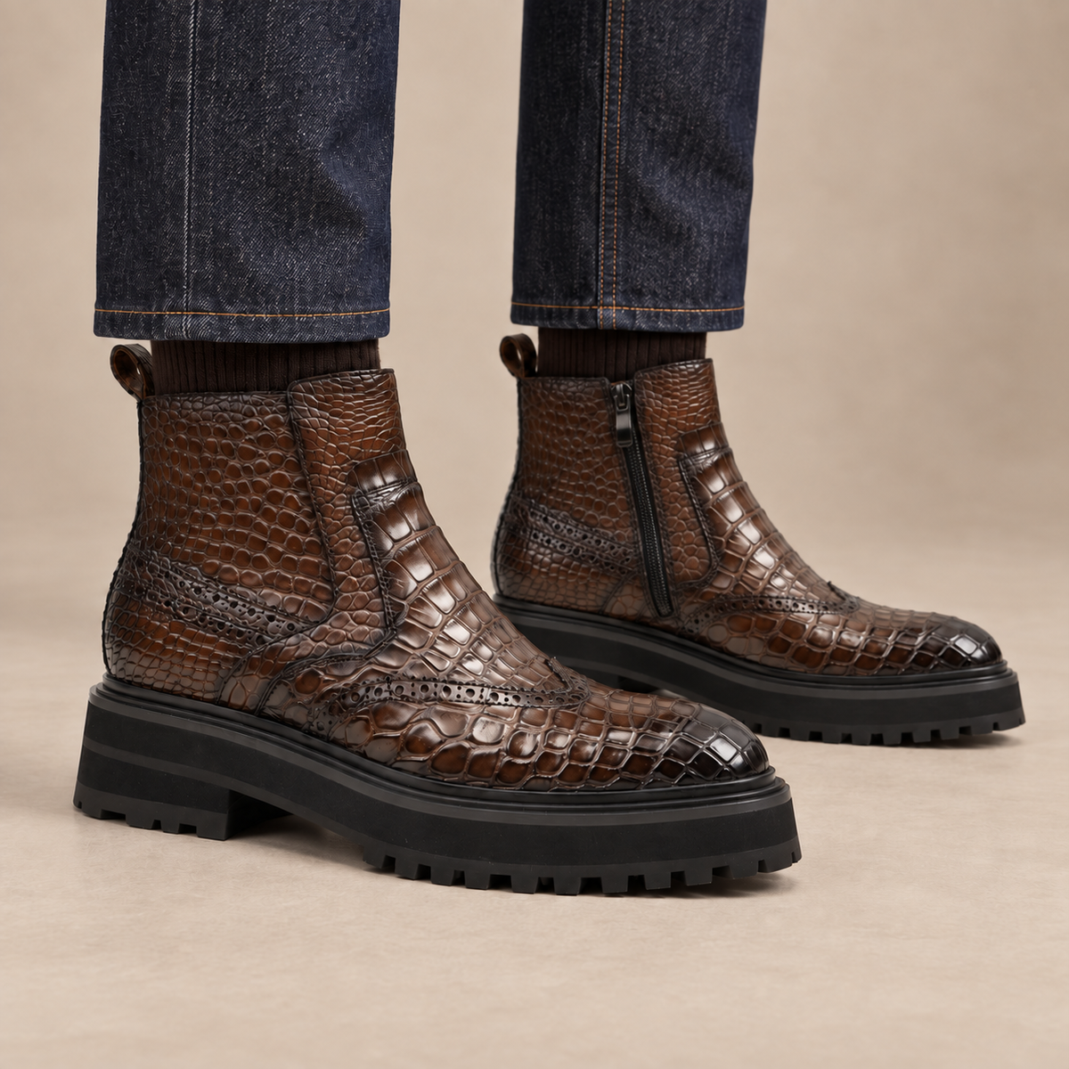 Dark brown crocodile-textured lug sole side-zip ankle boots on foot