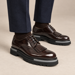DIVINCH dark brown glossy kiltie fringe Derby shoes worn with tailored navy trousers