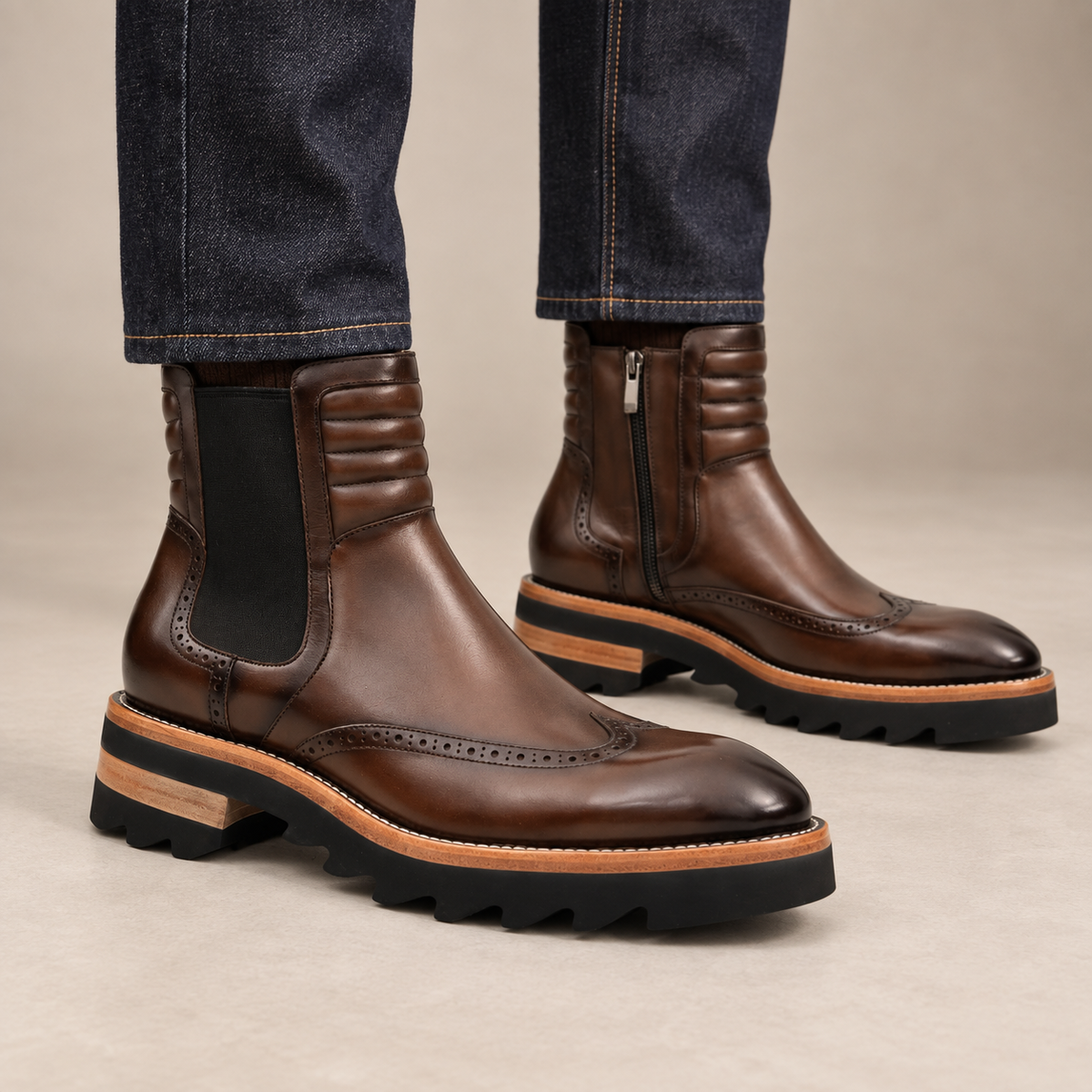 Dark brown lug sole wingtip Chelsea ankle boots — on-foot studio view
