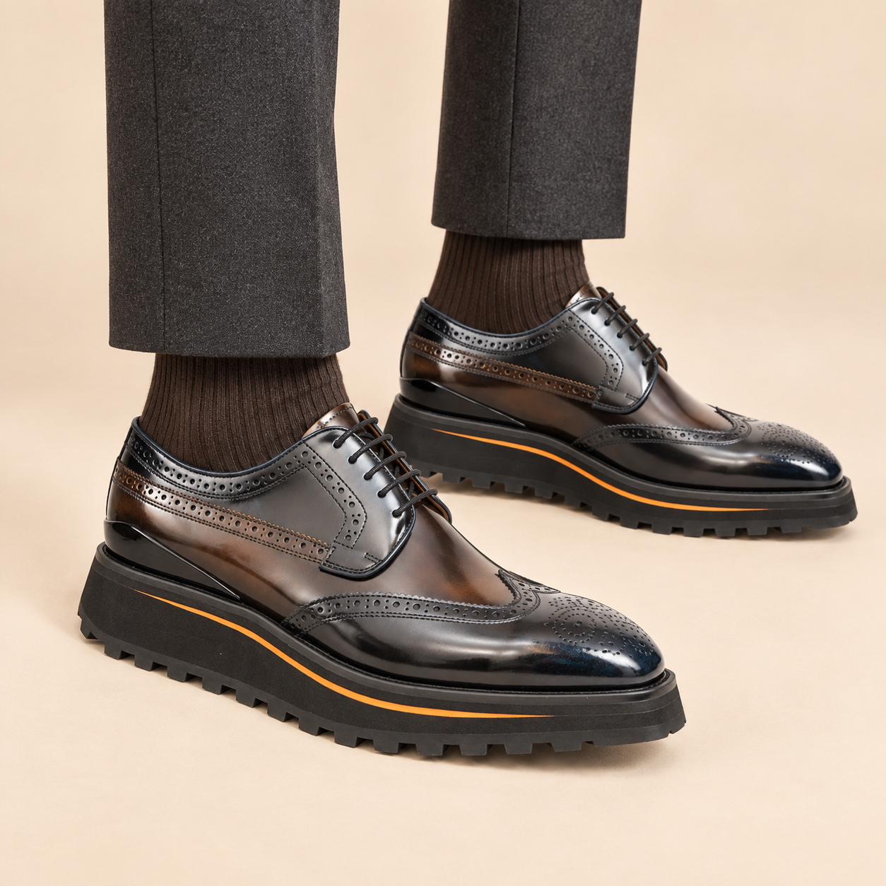 Dark brown wingtip Derby shoes with contrast-edge lug sole on model