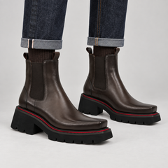 Dark coffee glossy square-toe Chelsea ankle boots on foot