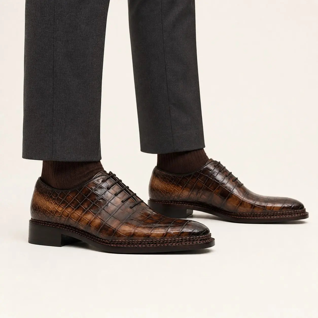 Brown crocodile Oxford shoes on foot