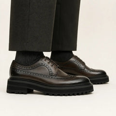 DIVINCH Espresso Lug Wingtip Derby on foot — warm studio side profile
