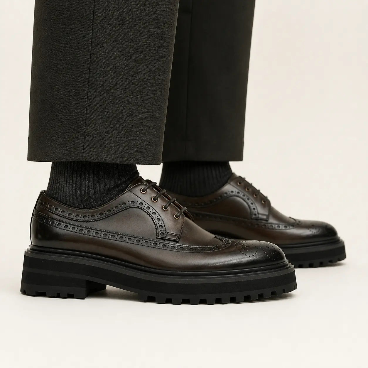 DIVINCH Espresso Lug Wingtip Derby on foot — warm studio side profile