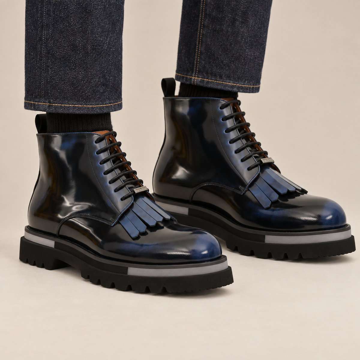 DIVINCH blue-shaded glossy plain-toe fringe ankle boots worn with raw indigo denim